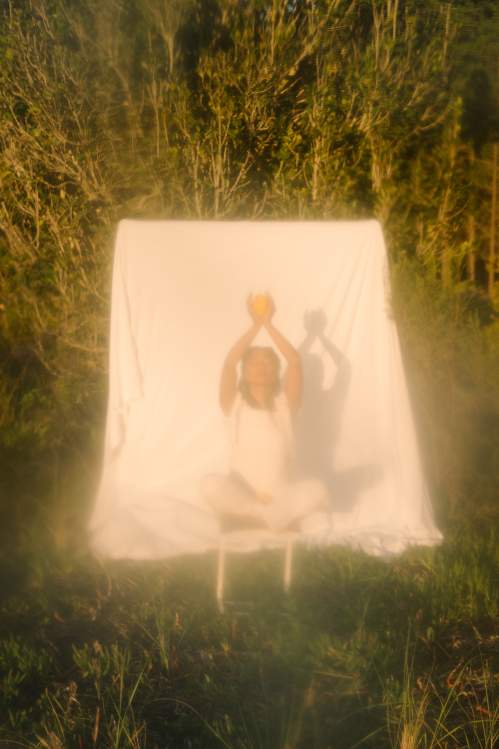 Woman Sitting Outdoors with White Cloth Background